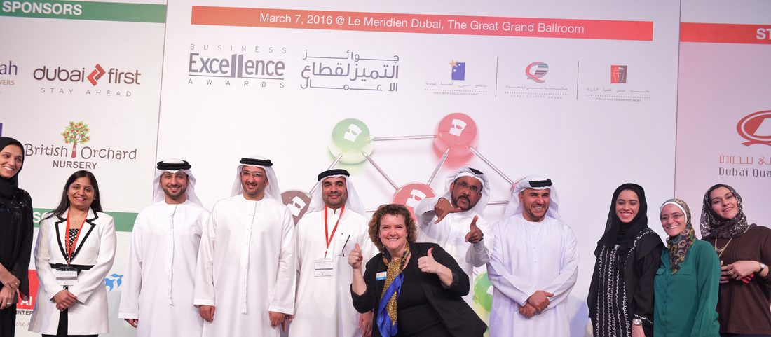 Jo-Dee Walmsley with the Attorney General of Dubai and government leaders on stage at the DED Business Excellence Awards.